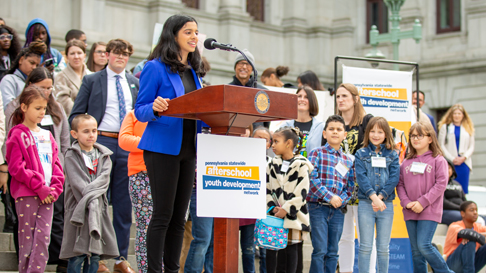 youth speaking at podium during Advocacy Day on Pennsylvania capitol steps.